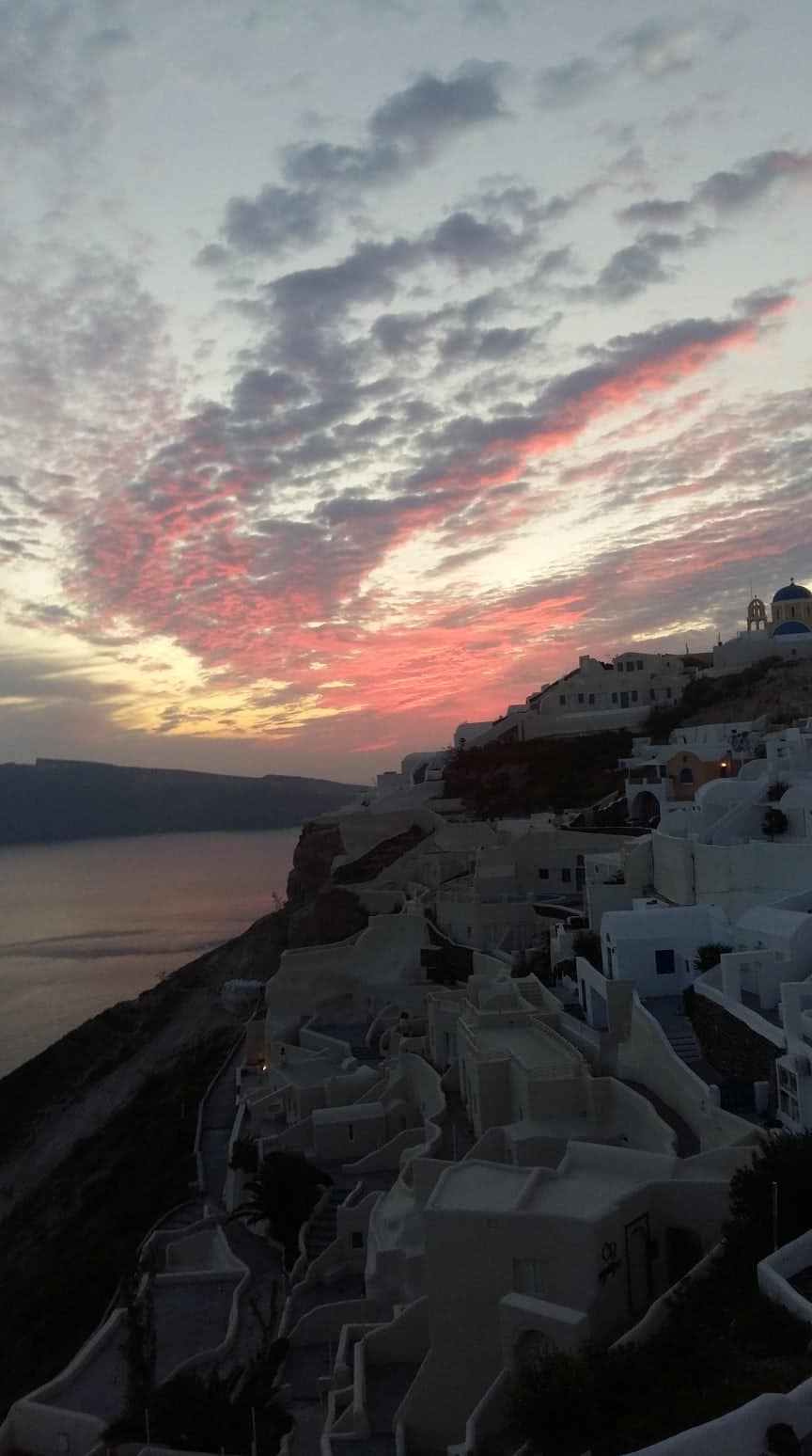 Whitewashed houses of Oia, Santorini, at sunset above the caldera