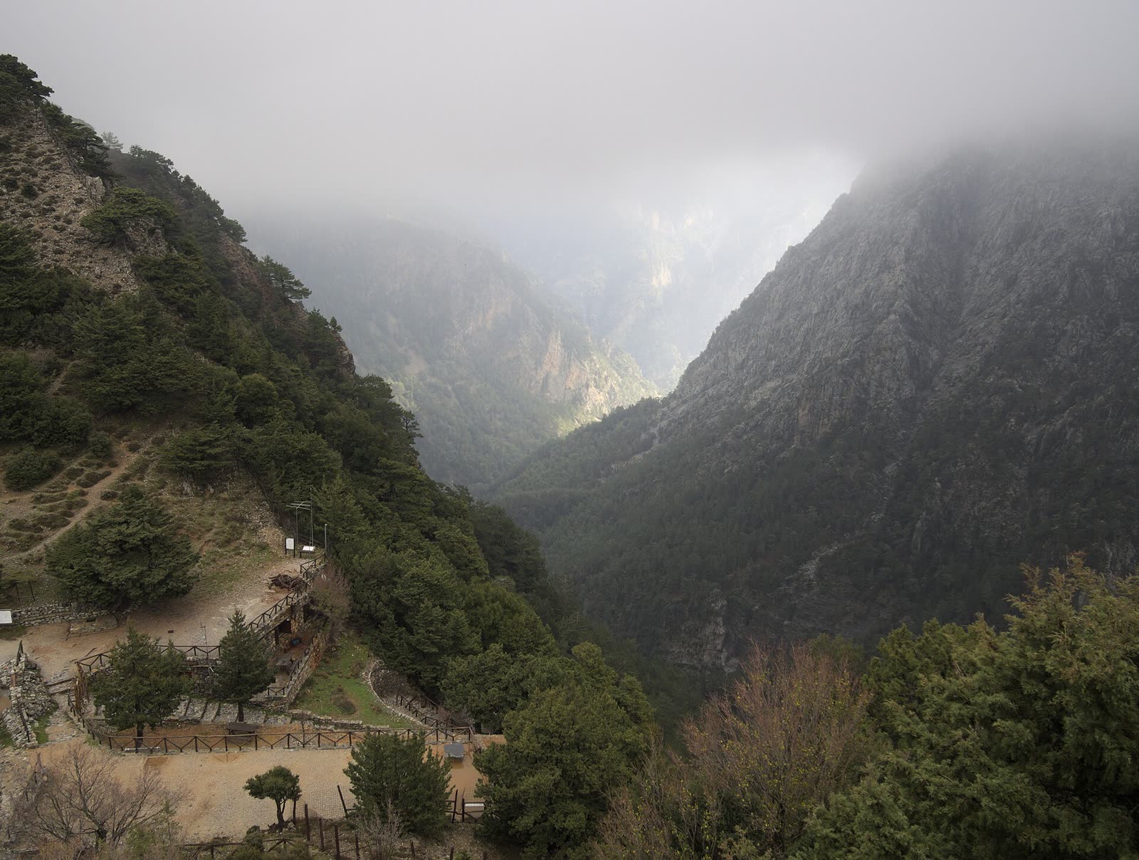 Hikers passing through the towering rock walls of the Samaria Gorge